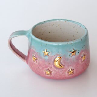 Moon and stars sky stoneware mug on the table
