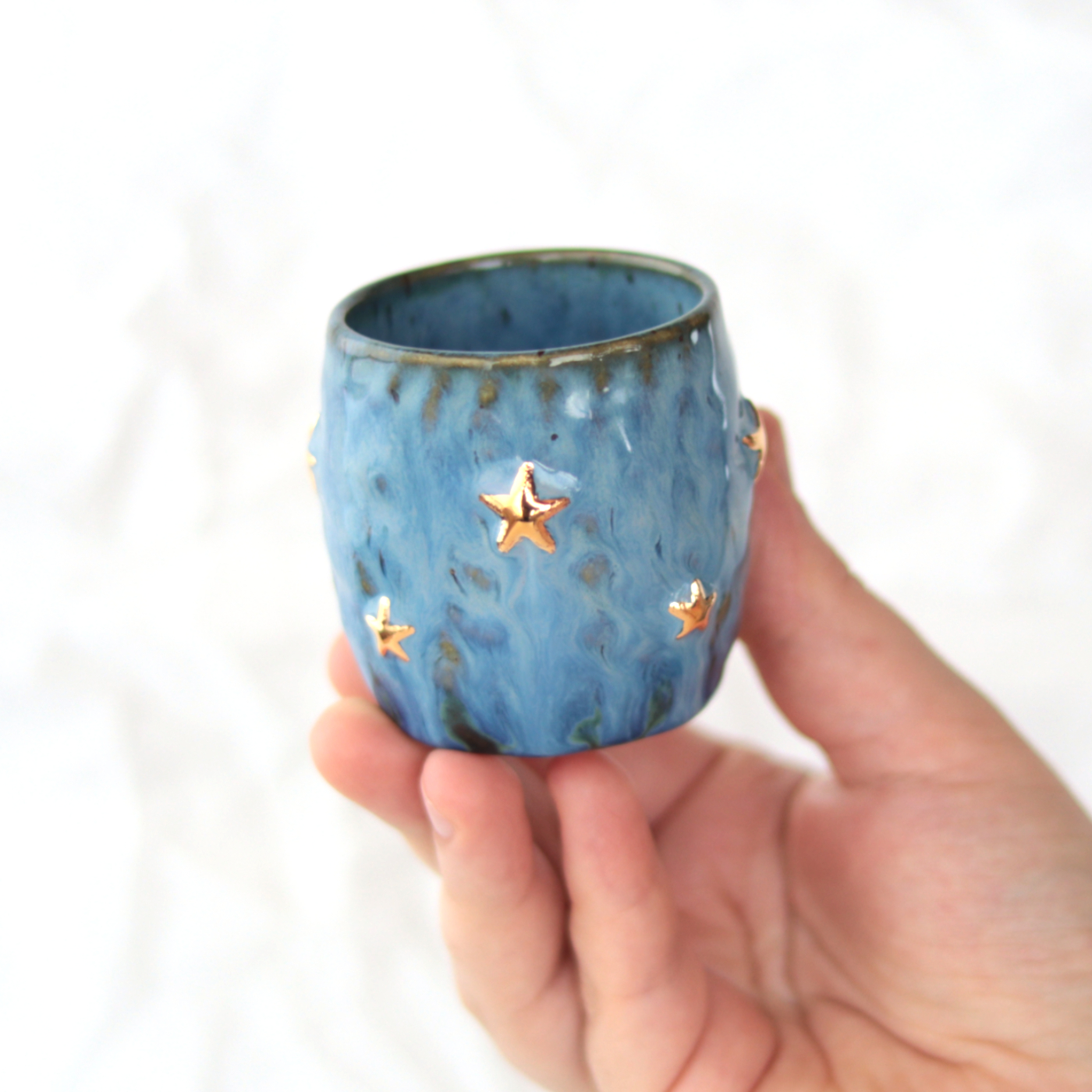 Handmade stoneware pinched blue espresso cup with gold stars - on hand Handmade stoneware pinched blue espresso cup with gold stars - on hand