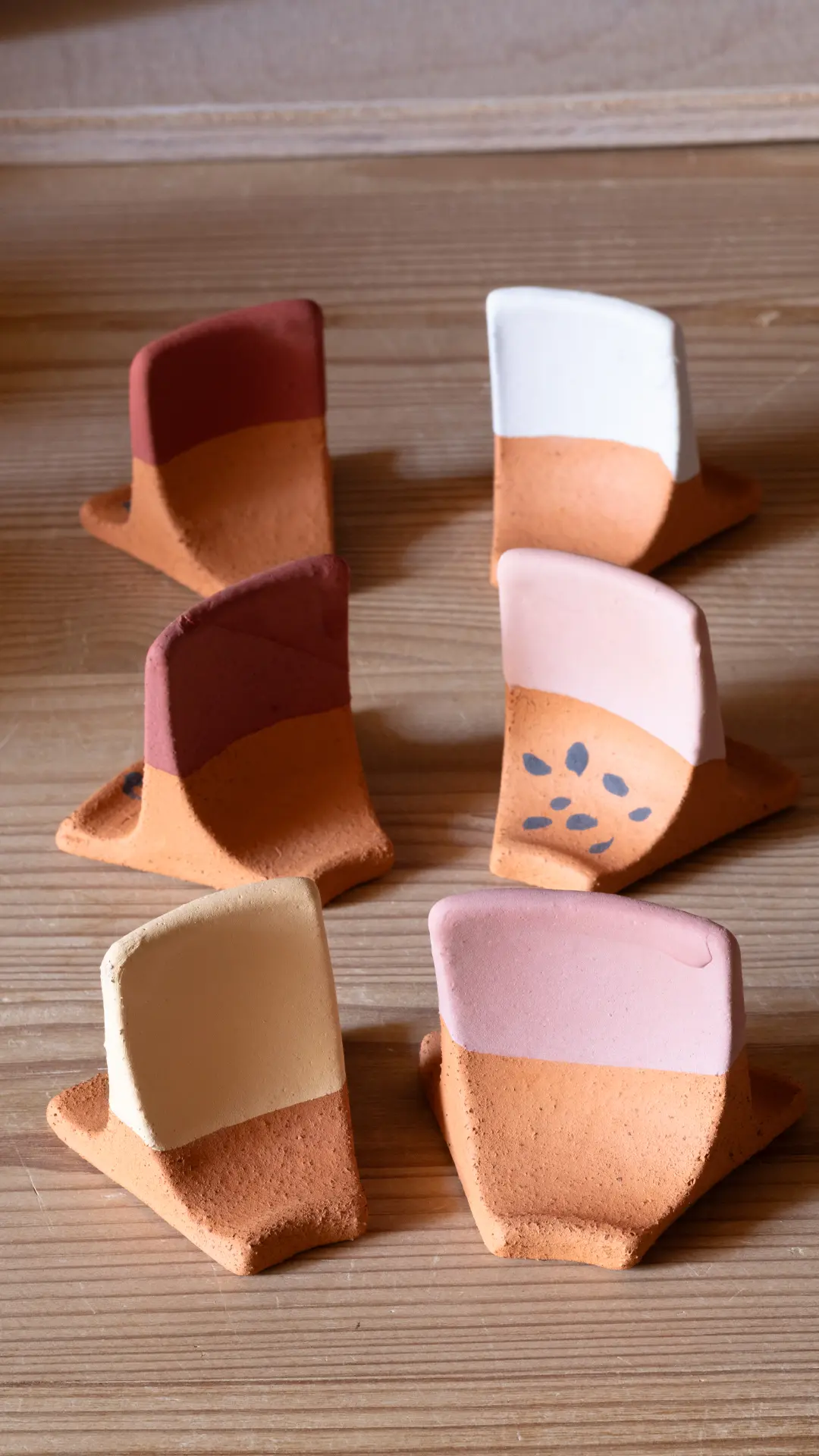 Artisanal glaze trials on stoneware test tiles by Seyma Ates, ready for firing.