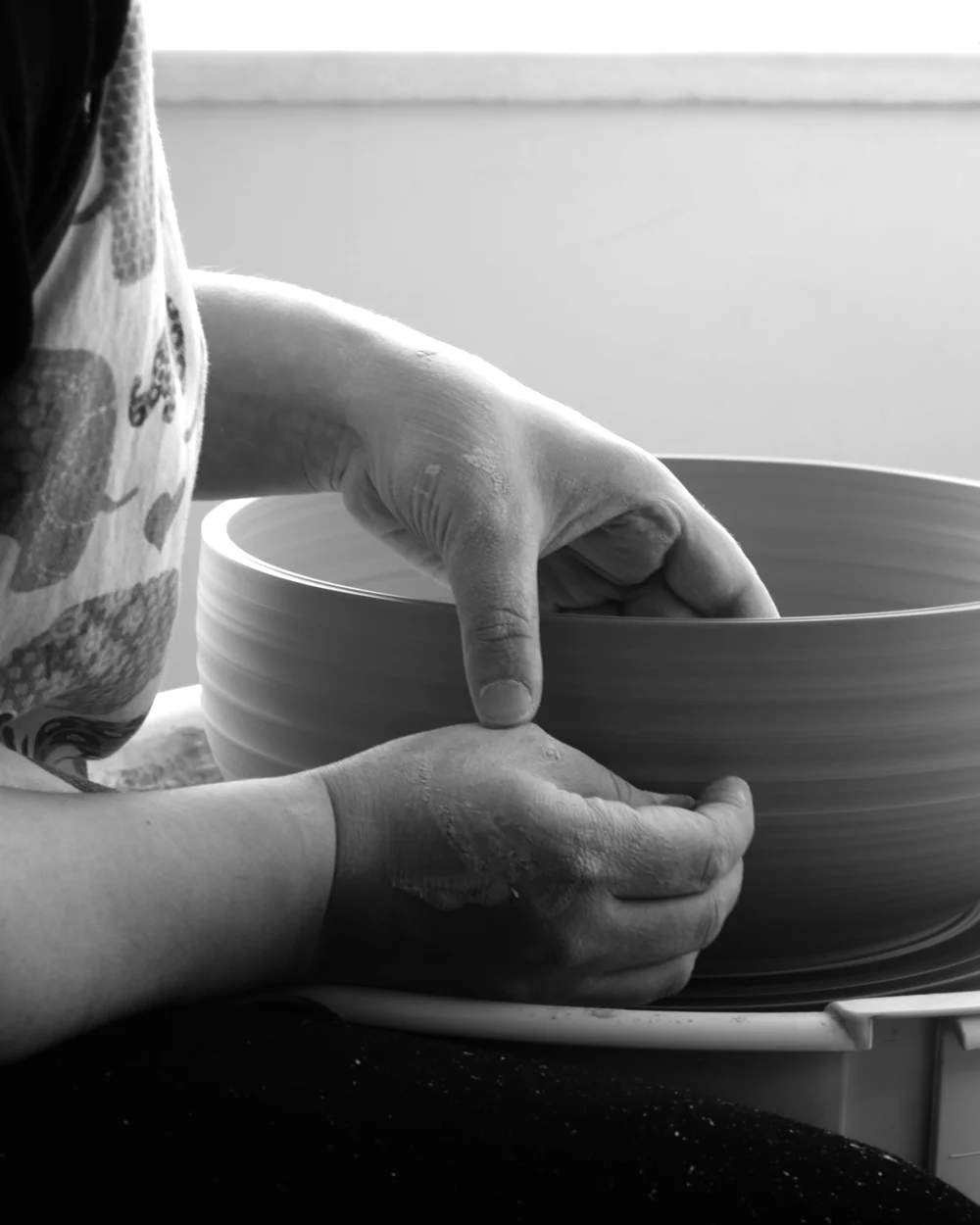 Ceramic artist Seyma Ates handcrafting a clay bowl on a pottery wheel