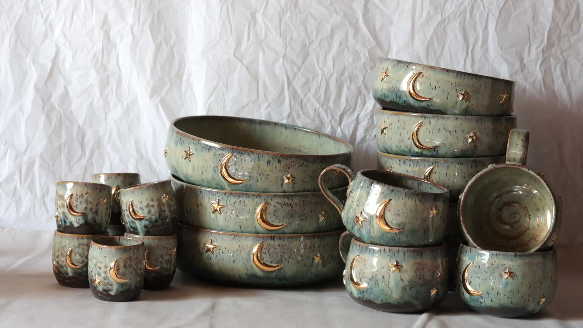 Artisanal pottery collection with gold moon and star details - Handcrafted ceramics by Seyma Ates