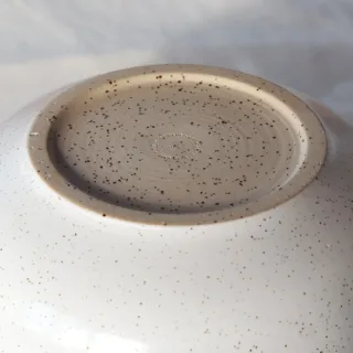 Bottom of handmade speckled stoneware bowl showing Seyma Ates Studio stamp — not microwave safe ceramic
