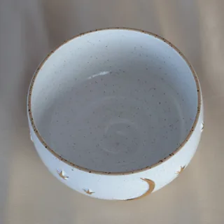 Speckled white stoneware bowl with gold crescent moon and stars — top view — handmade by Seyma Ates